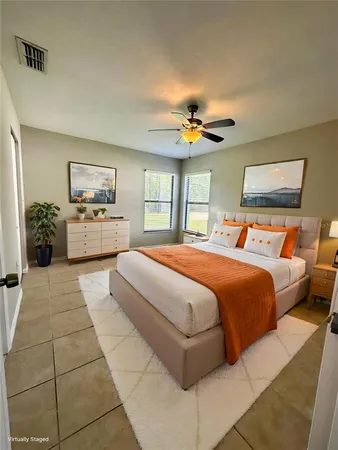 a bedroom with a large bed and a chandelier
