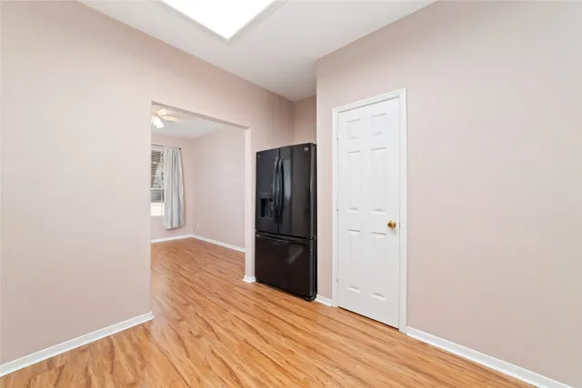 a view of an empty room with wooden floor