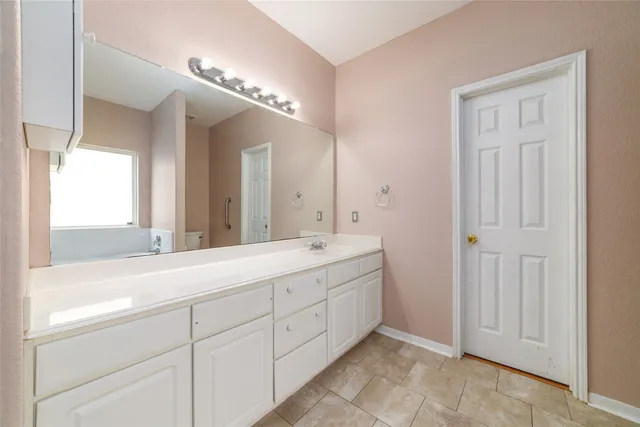 a spacious bathroom with a double vanity sink mirror and