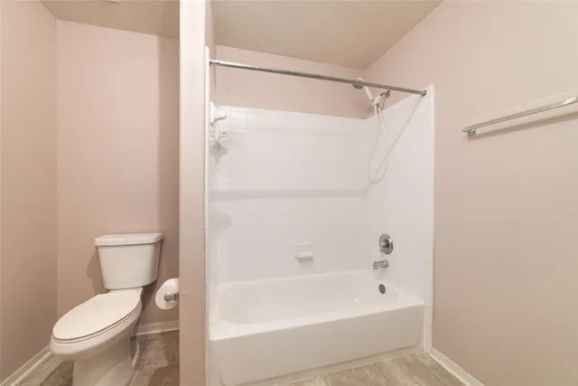 a bathroom with a toilet and a bathtub