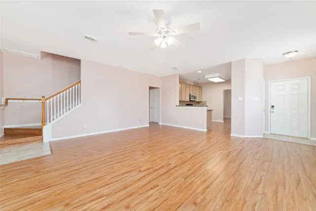 a view of a kitchen with wooden floor and a kitchen