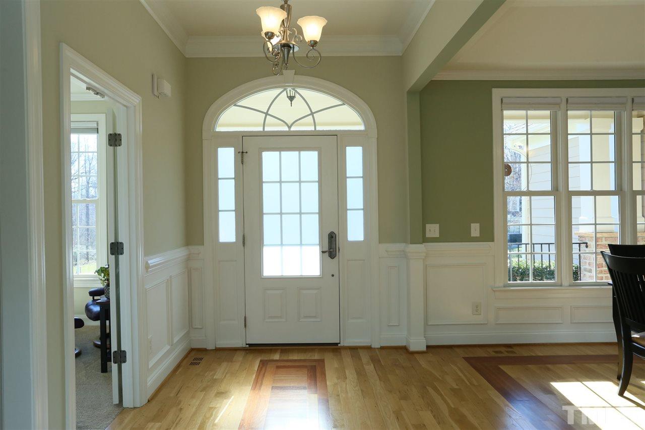 303 May Farm Road Pittsboro, NC 27312 - Photo 2 of 25 Bright and sunny with inlays in hardwood floors.