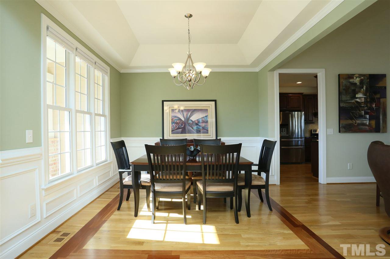 303 May Farm Road Pittsboro, NC 27312 - Photo 3 of 25 Gorgeous details! Inlays in hardwood floor, wainscoting, tray ceiling.