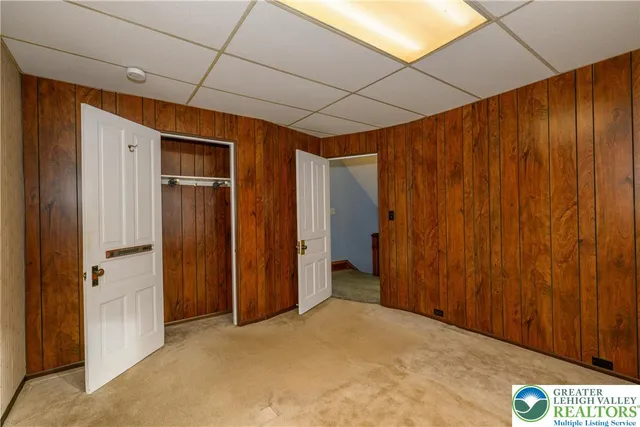 a room with pool table and windows
