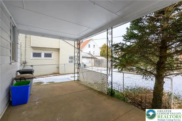 an aerial view of a house with garden space and street view