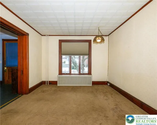 en empty room with windows and ceiling fan