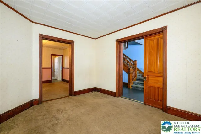 a kitchen with white cabinets and a window