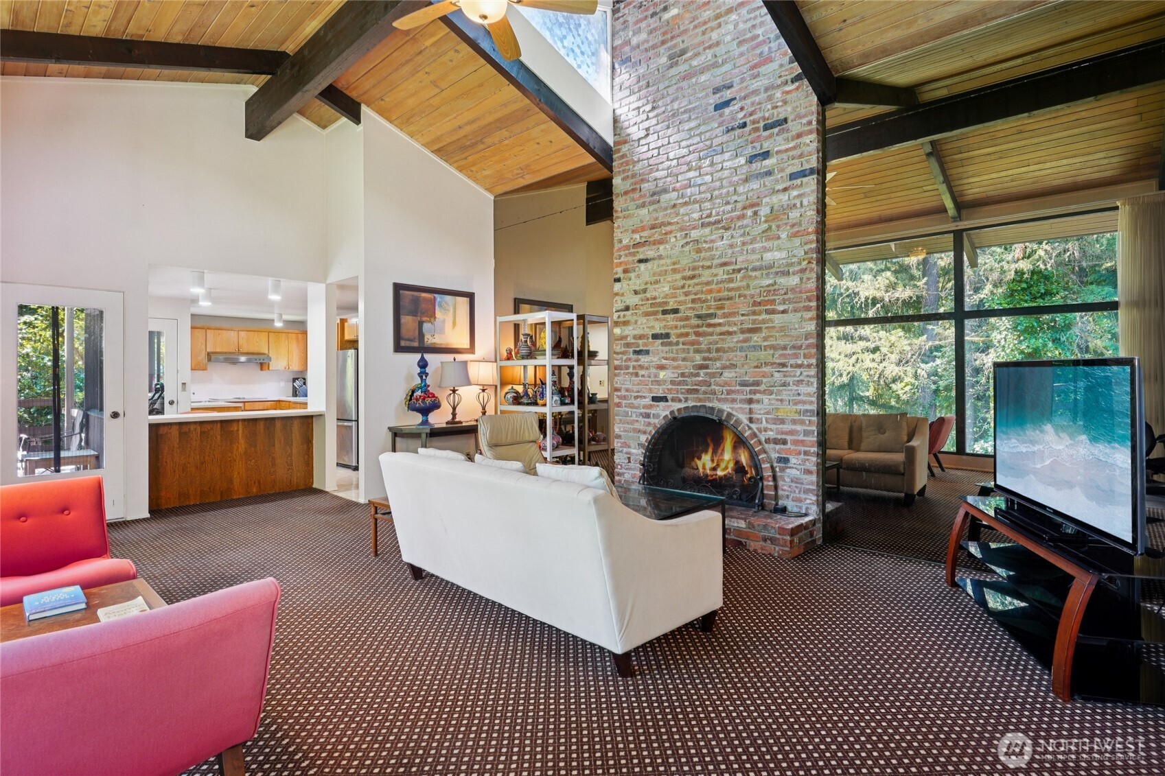 19419 Grannis Road Bothell, WA 98012 - Photo 19 of 40 a living room with furniture a fireplace wooden floor and a large window