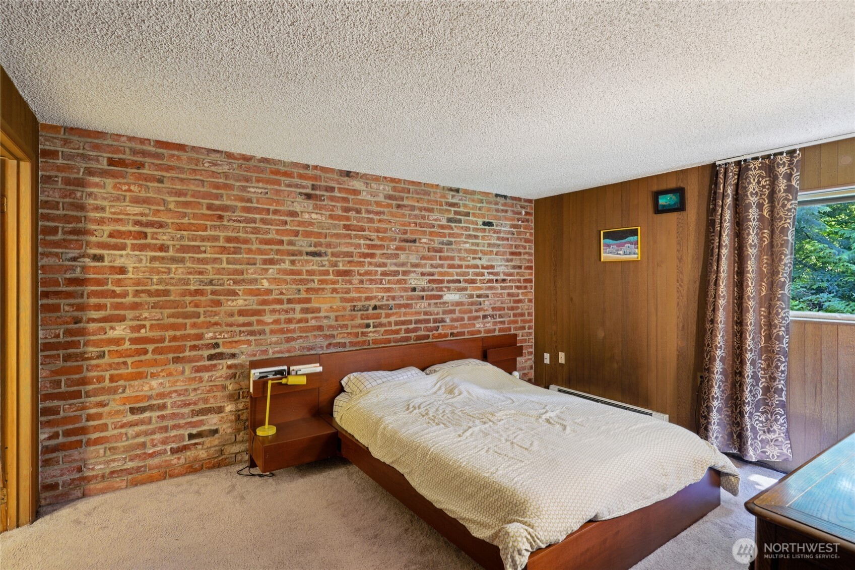 19419 Grannis Road Bothell, WA 98012 - Photo 29 of 40 a bedroom with a bed and a flat screen tv