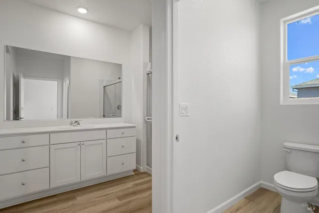 a bathroom with a shower sink vanity and mirror