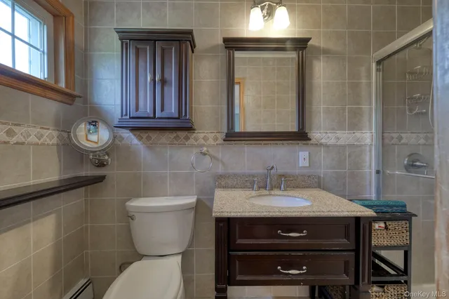 a bathroom with a toilet a sink and a window