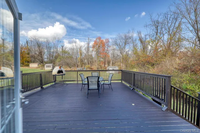 a view of a lake with a table and chairs