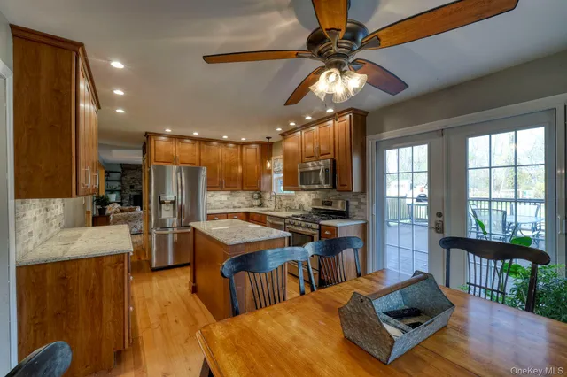 a living room with stainless steel appliances kitchen island granite countertop furniture and a kitchen view