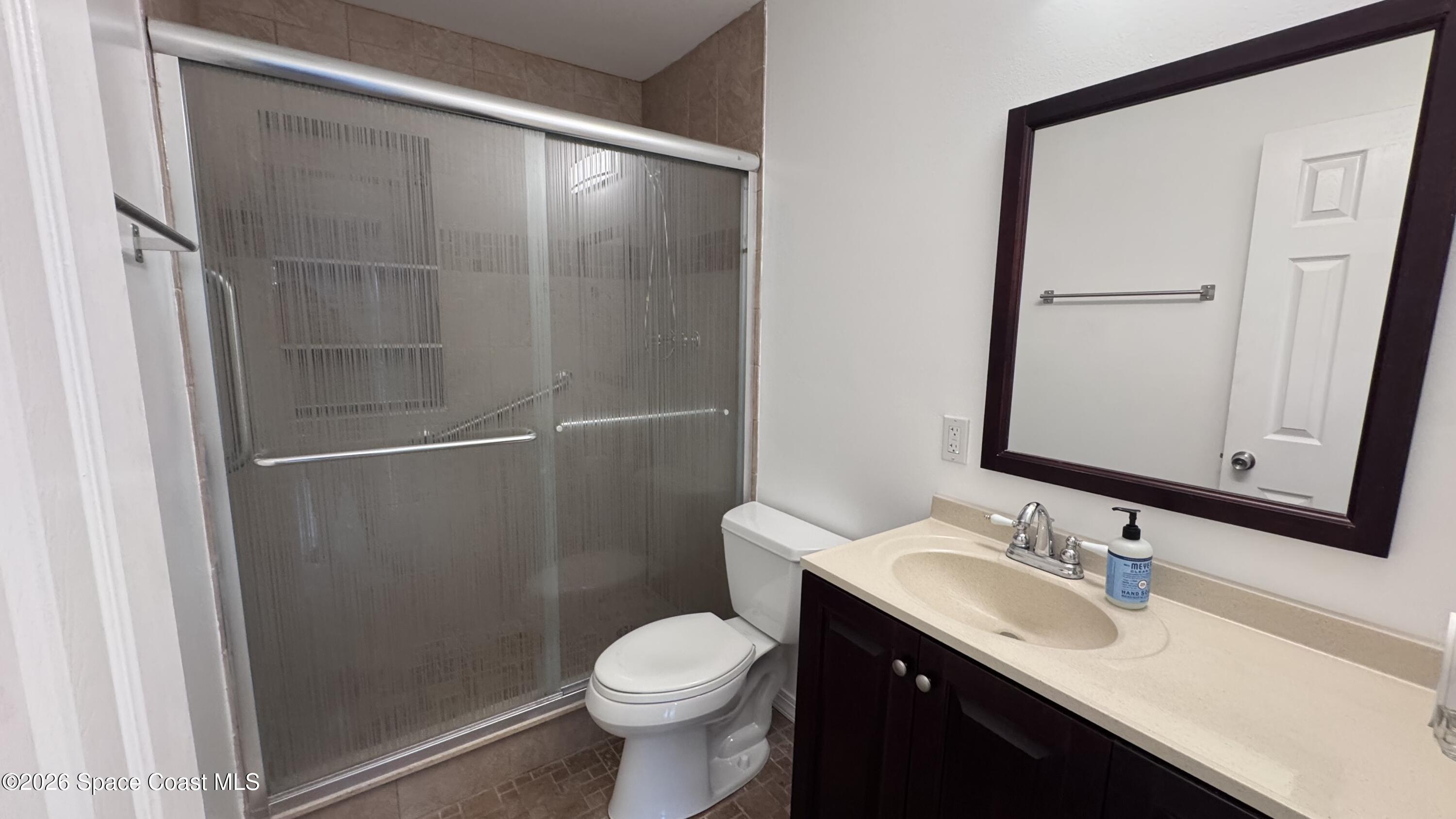 2137 Laden Road Melbourne, FL 32935 - Photo 15 of 23 a bathroom with a granite countertop sink toilet and shower