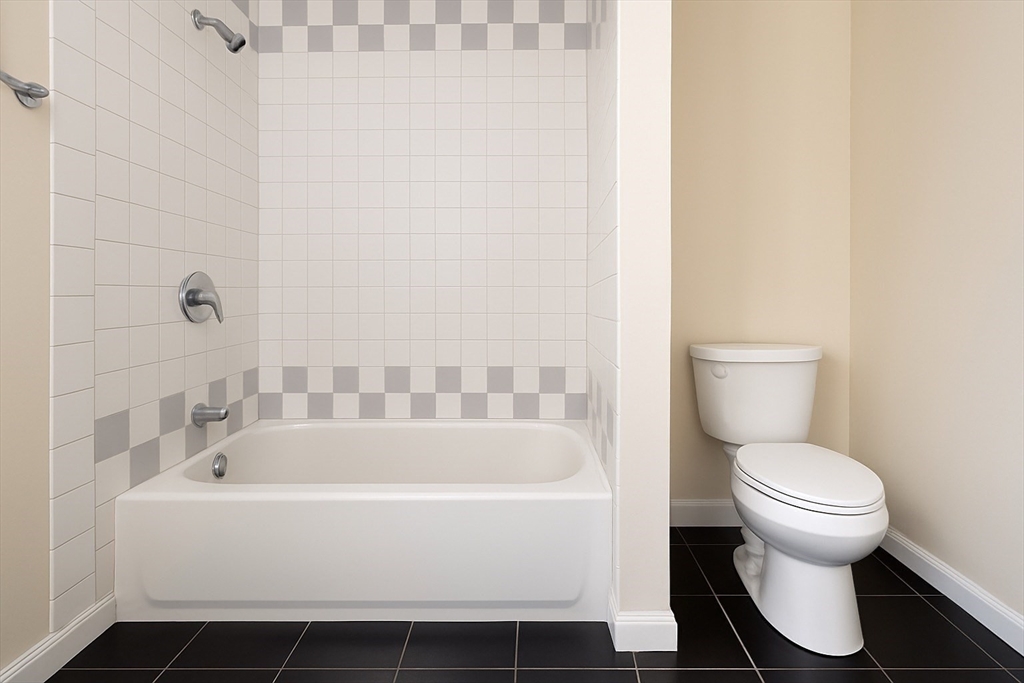 65 School Street Gardner, MA 01440 - Photo 13 of 21 a white bath tub sitting next to a white toilet