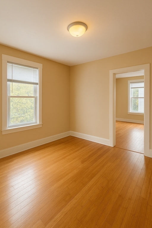 65 School Street Gardner, MA 01440 - Photo 15 of 21 wooden floor in an empty room with a window
