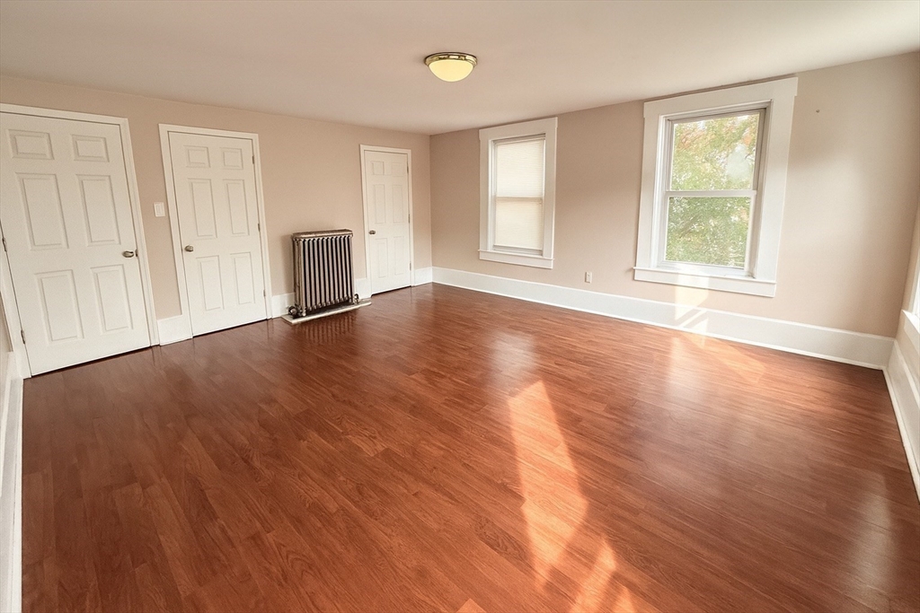 65 School Street Gardner, MA 01440 - Photo 17 of 21 an empty room with wooden floor and windows