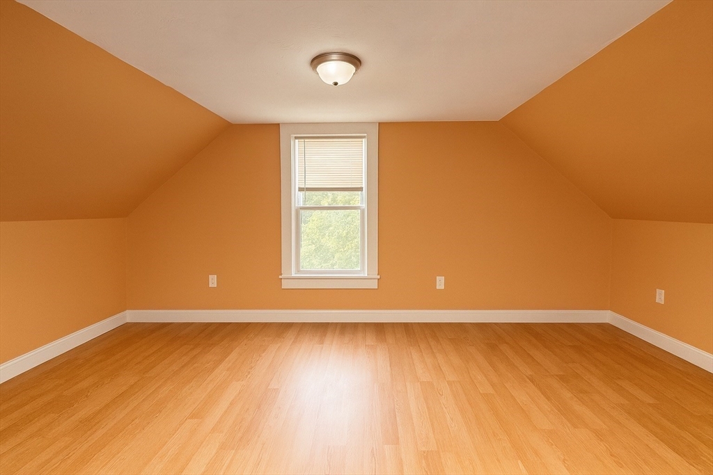 65 School Street Gardner, MA 01440 - Photo 18 of 21 a view of an empty room with wooden floor and a window