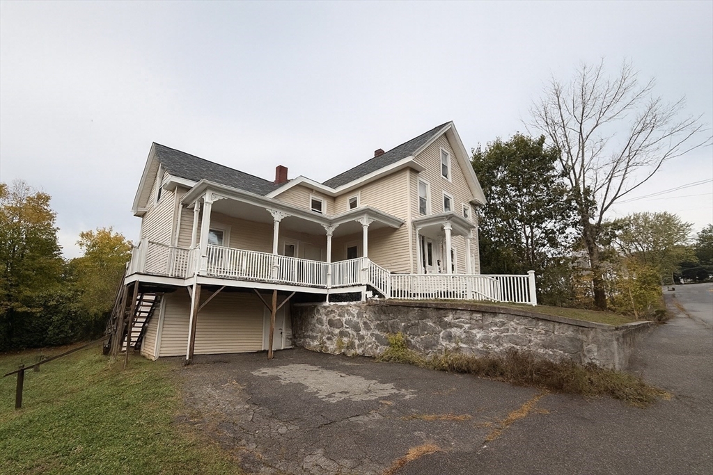 65 School Street Gardner, MA 01440 - Photo 2 of 21 a front view of a house with a garden