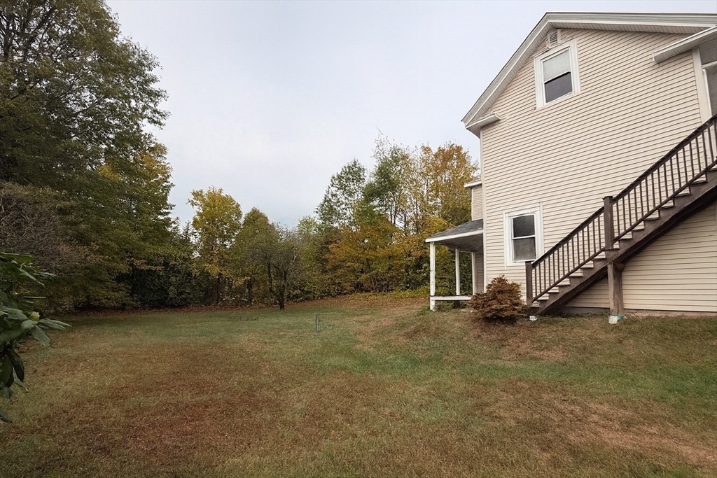 65 School Street Gardner, MA 01440 - Photo 3 of 21 a view of a house with backyard and trees