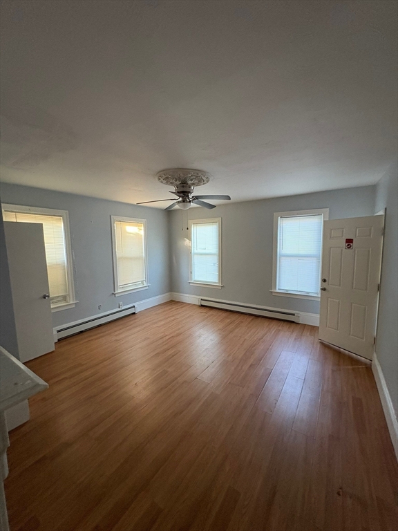 65 School Street Gardner, MA 01440 - Photo 10 of 21 an empty room with wooden floor and windows