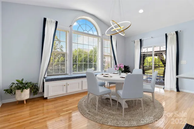 a dining room with furniture a potted plant and a rug