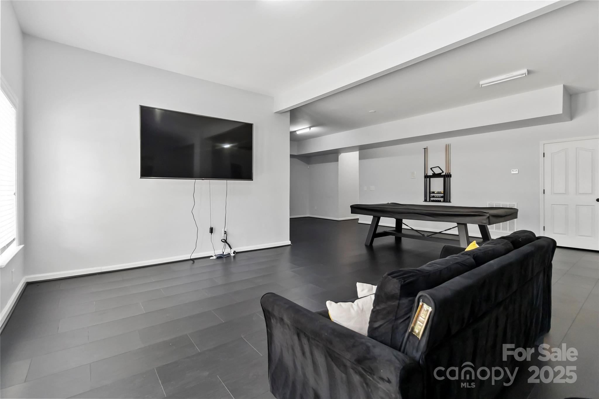 1009 Murandy Lane Matthews, NC 28104 - Photo 43 of 48 a living room with furniture and a flat screen tv