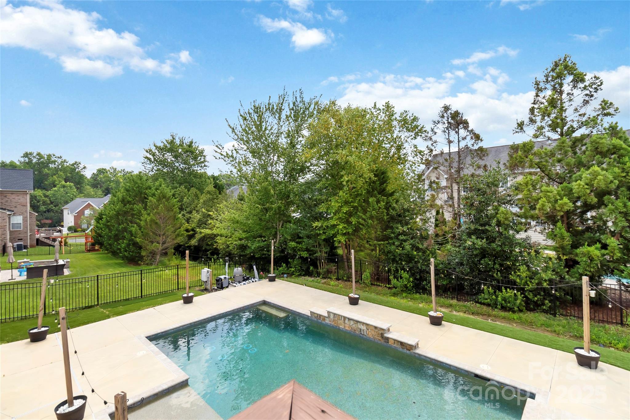 1009 Murandy Lane Matthews, NC 28104 - Photo 46 of 48 a swimming pool with trees in the background