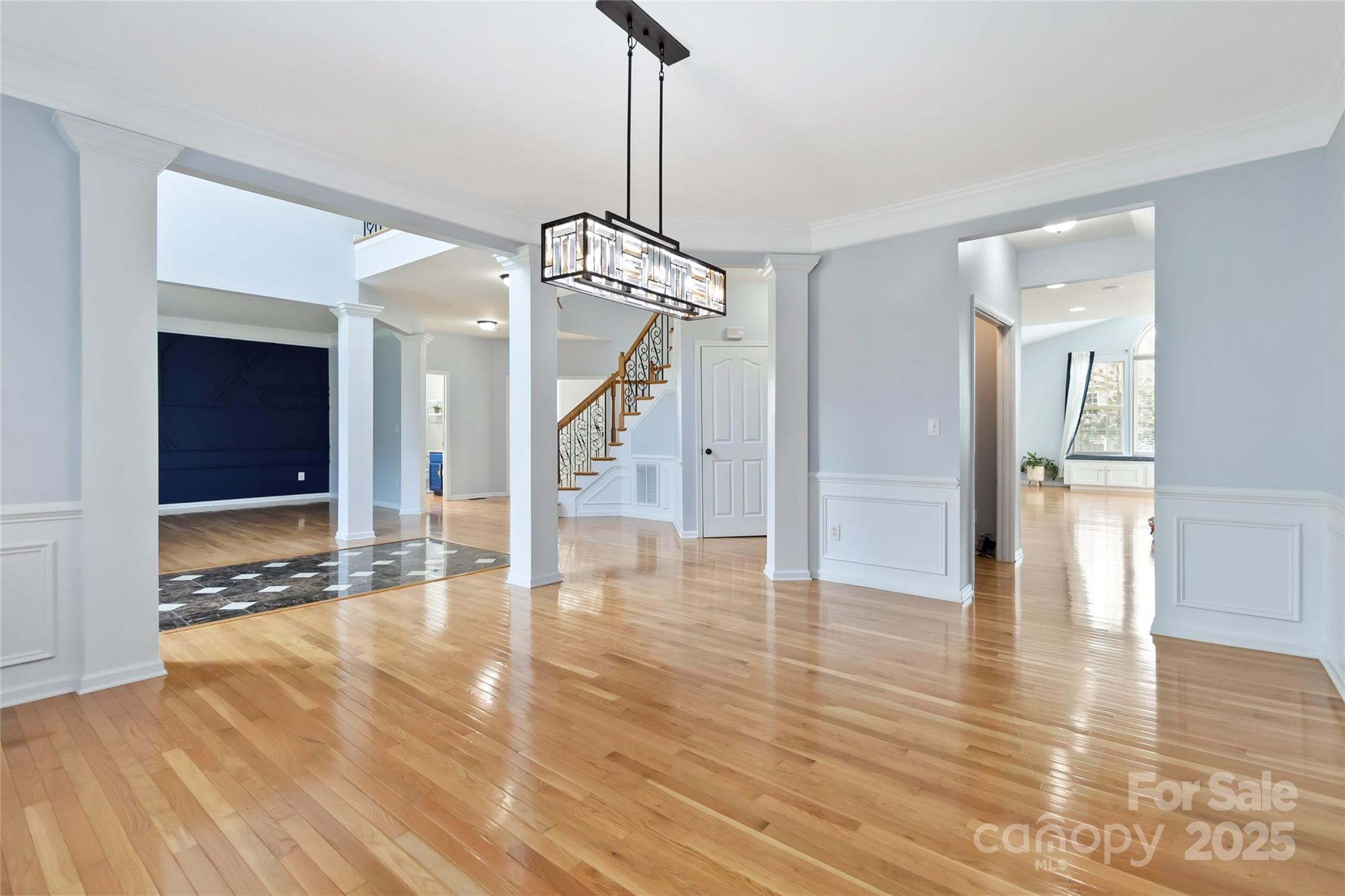 1009 Murandy Lane Matthews, NC 28104 - Photo 7 of 48 a view of a hallway with wooden floor and a living room