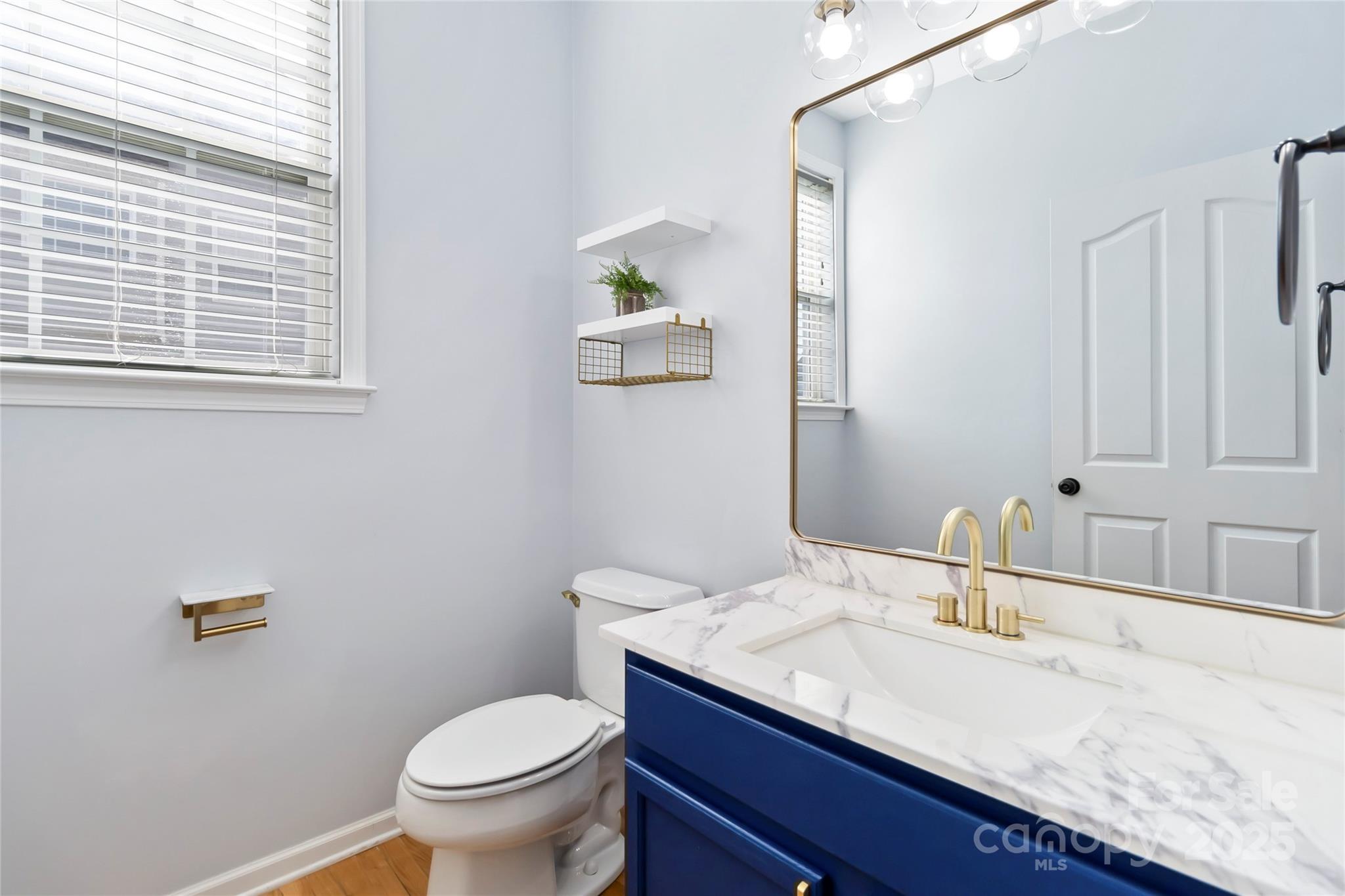 1009 Murandy Lane Matthews, NC 28104 - Photo 8 of 48 a bathroom with a granite countertop toilet sink and mirror