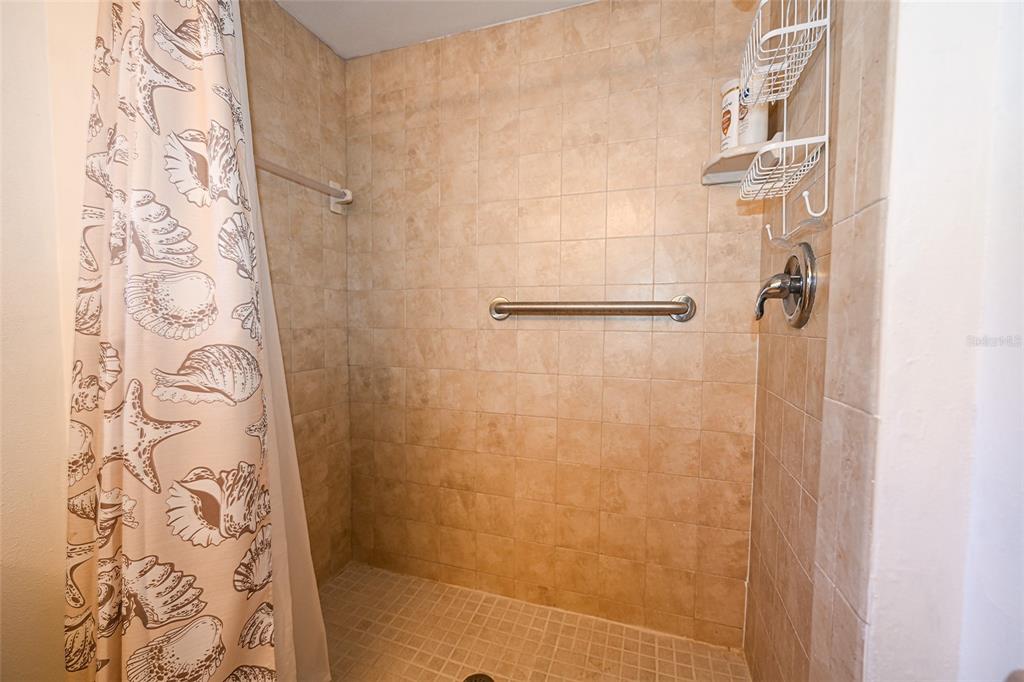 1731 Bonitas Circle, Unit 1720C Venice, FL 34293 - Photo 13 of 21 a bathroom with a shower