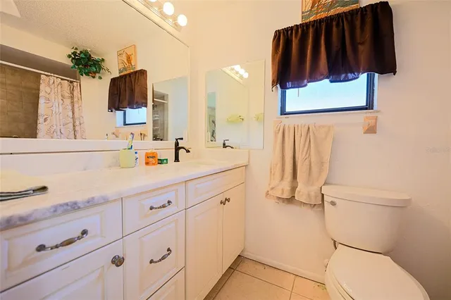 a bedroom with a bed and dresser with mirror