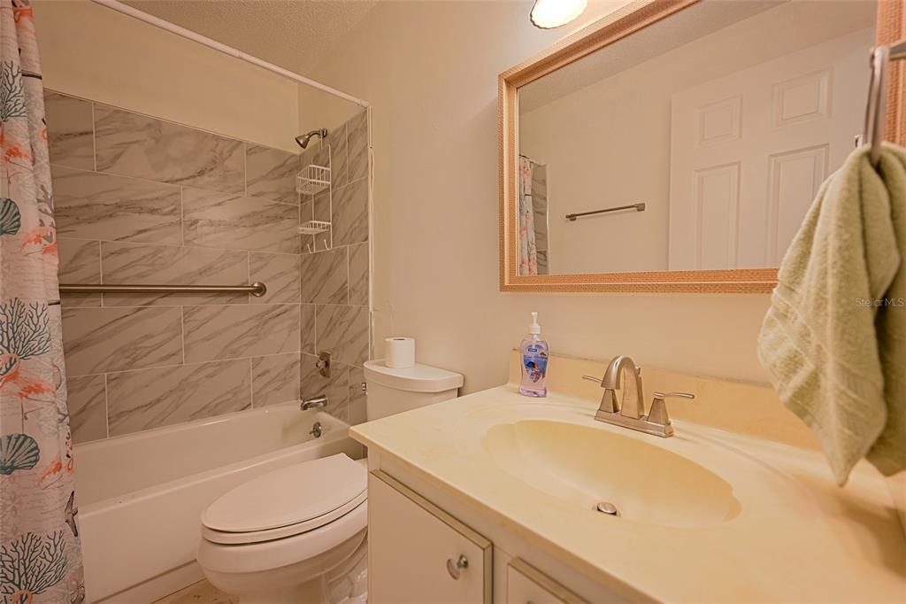 1731 Bonitas Circle, Unit 1720C Venice, FL 34293 - Photo 16 of 21 a bathroom with a sink toilet and shower
