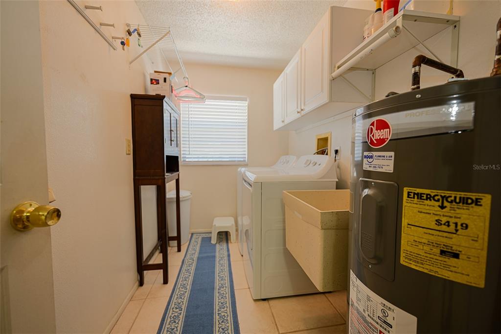 1731 Bonitas Circle, Unit 1720C Venice, FL 34293 - Photo 17 of 21 a utility room with dryer and washer