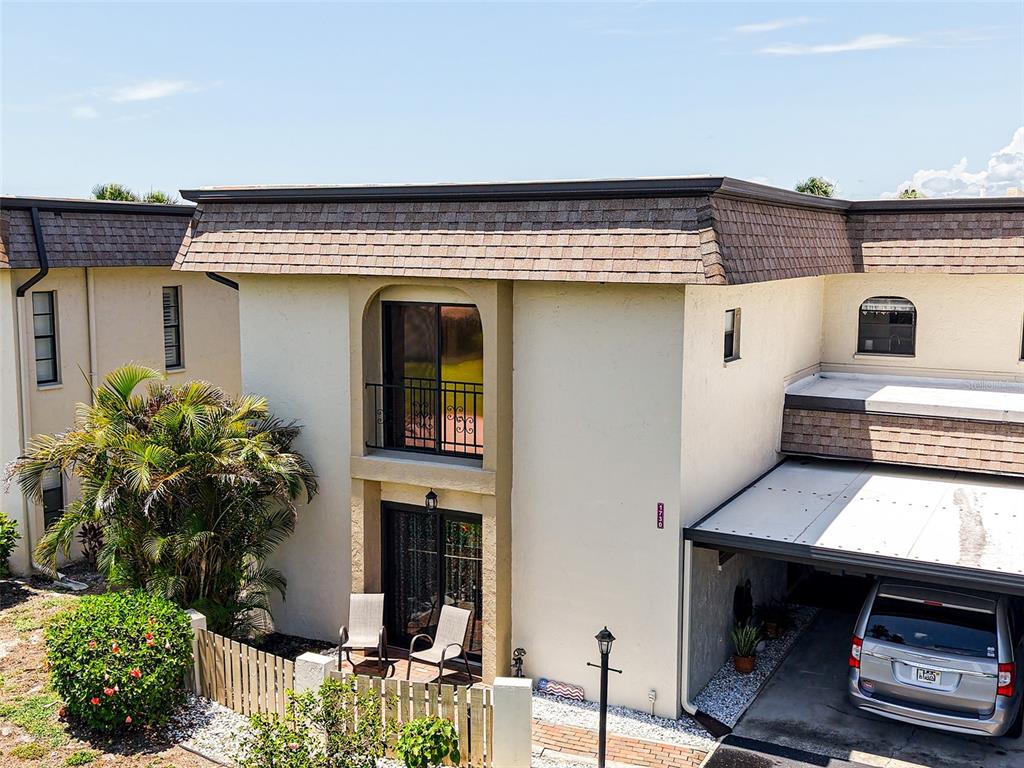 1731 Bonitas Circle, Unit 1720C Venice, FL 34293 - Photo 18 of 21 a front view of a house with plants