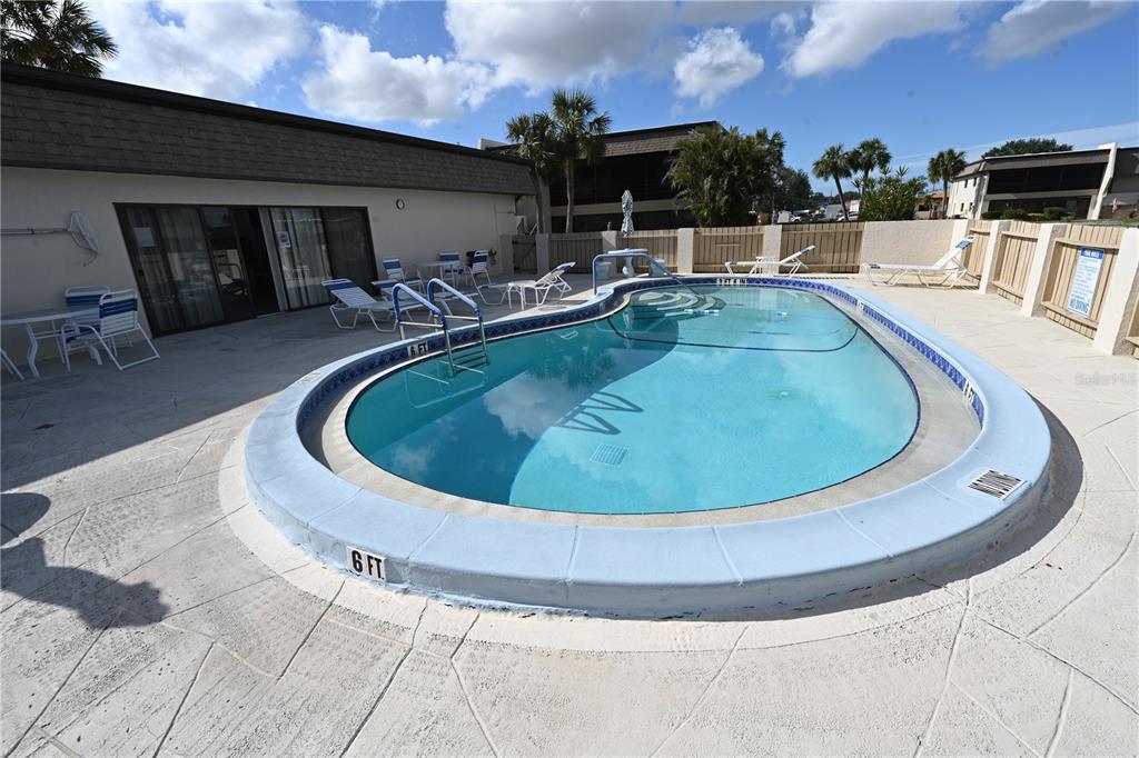 1731 Bonitas Circle, Unit 1720C Venice, FL 34293 - Photo 19 of 21 a view of a swimming pool with back yard of a house