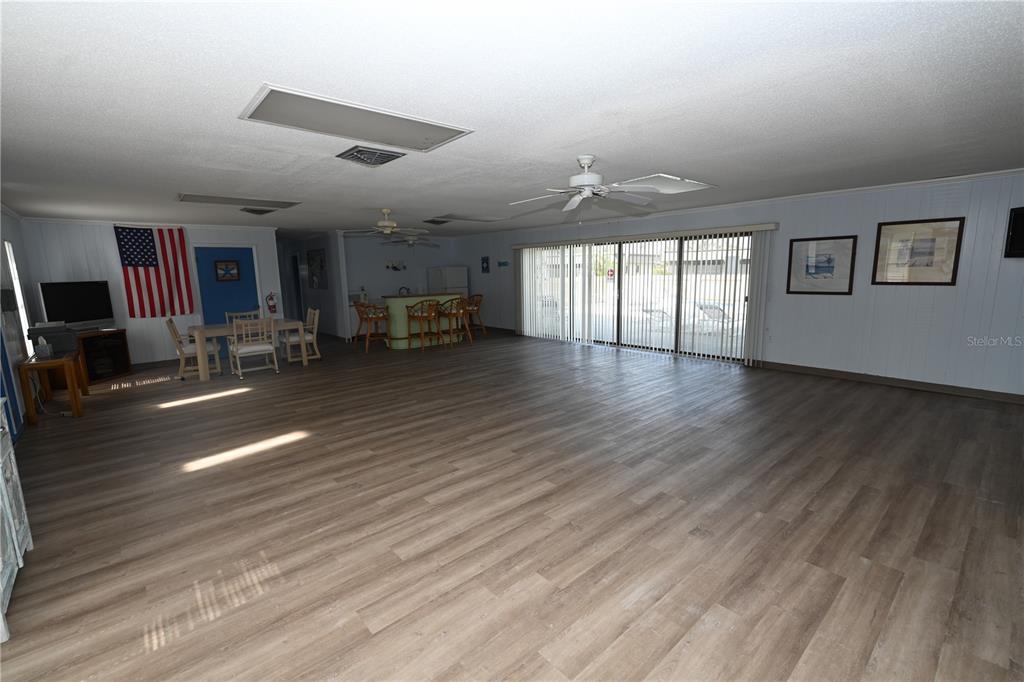 1731 Bonitas Circle, Unit 1720C Venice, FL 34293 - Photo 21 of 21 an empty room with wooden floor and windows