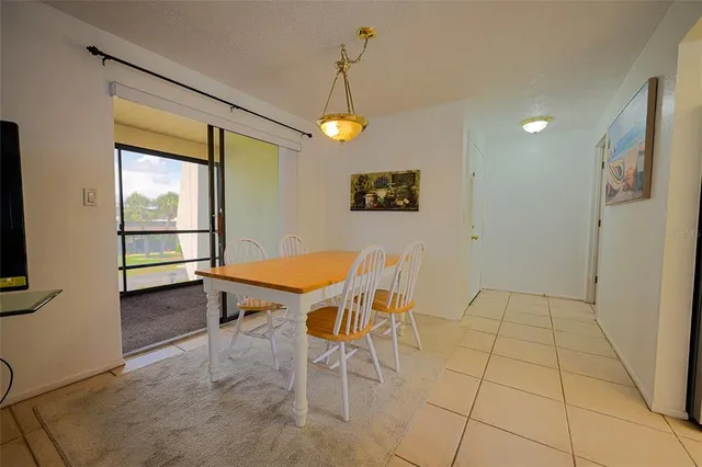 a view of a dining room with furniture wooden floor and chandelier