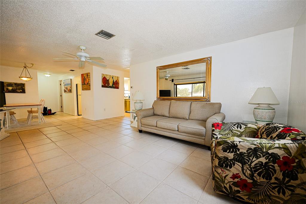 1731 Bonitas Circle, Unit 1720C Venice, FL 34293 - Photo 5 of 21 a living room with furniture and a couch