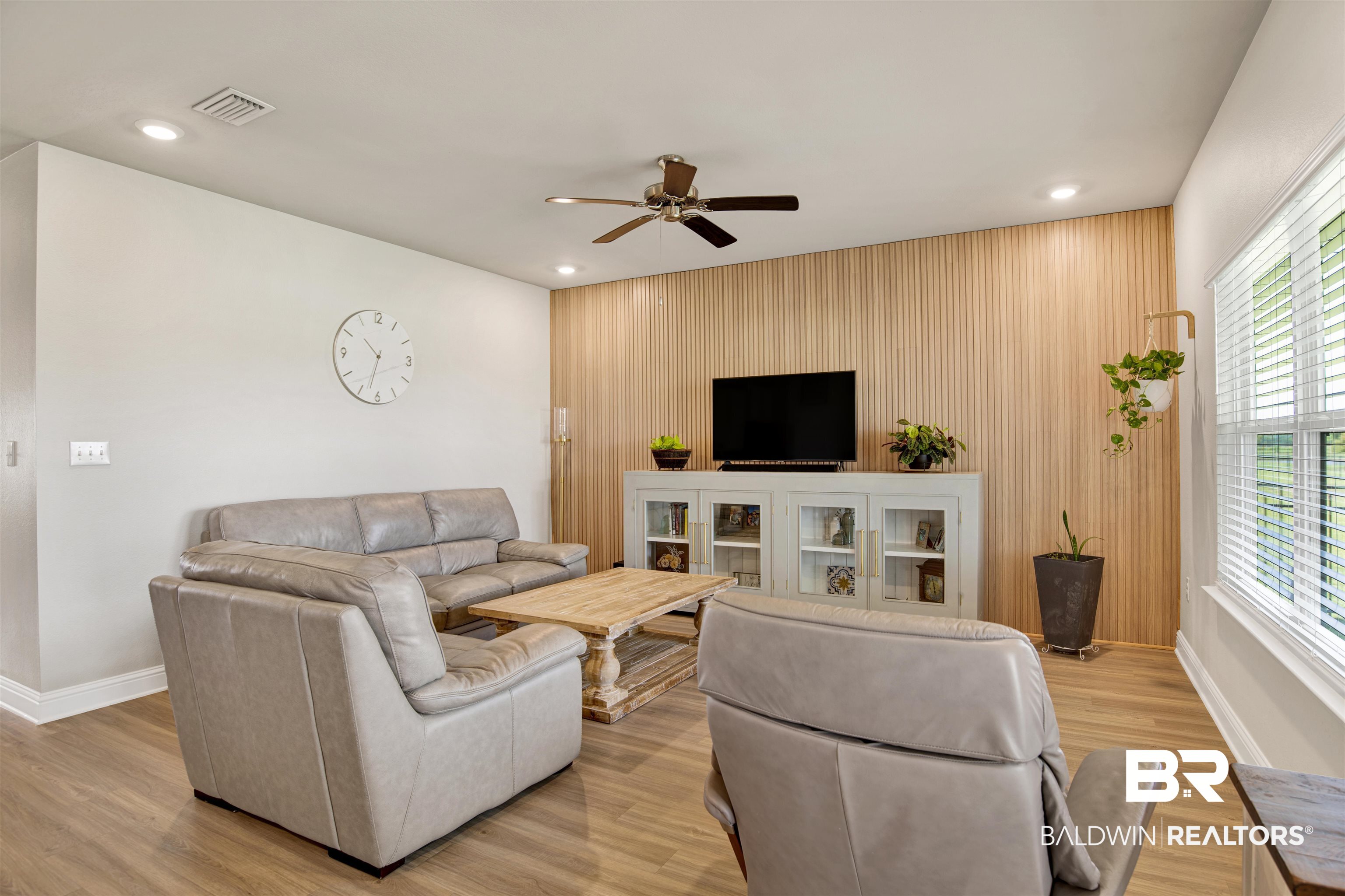 9431 Swan Point Road Daphne, AL 36526 - Photo 13 of 35 Living area with light wood finished floors, a ceiling fan, recessed lighting, wood walls, and an accent wall