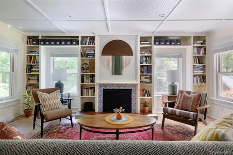 a living room with fireplace furniture and a fireplace