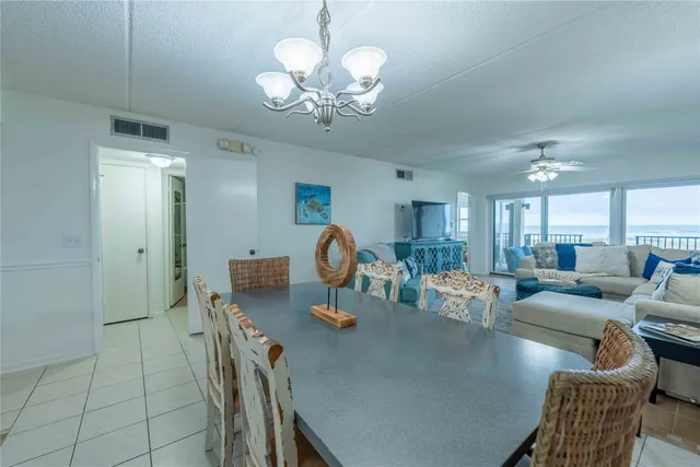 a dining room with furniture and a chandelier