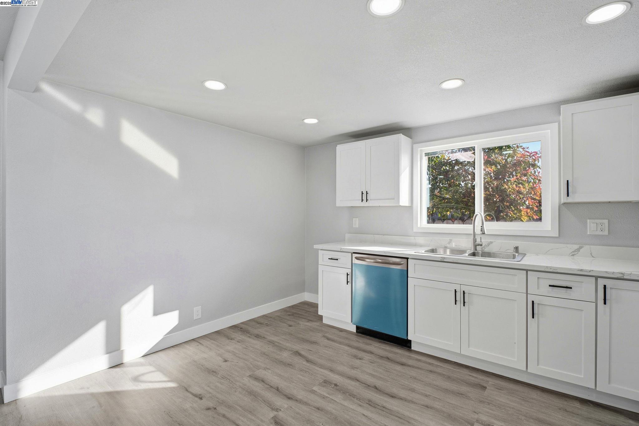 38016 Vallejo Street Fremont, CA 94536 - Photo 11 of 32 a kitchen with a sink cabinets wooden floor and a window