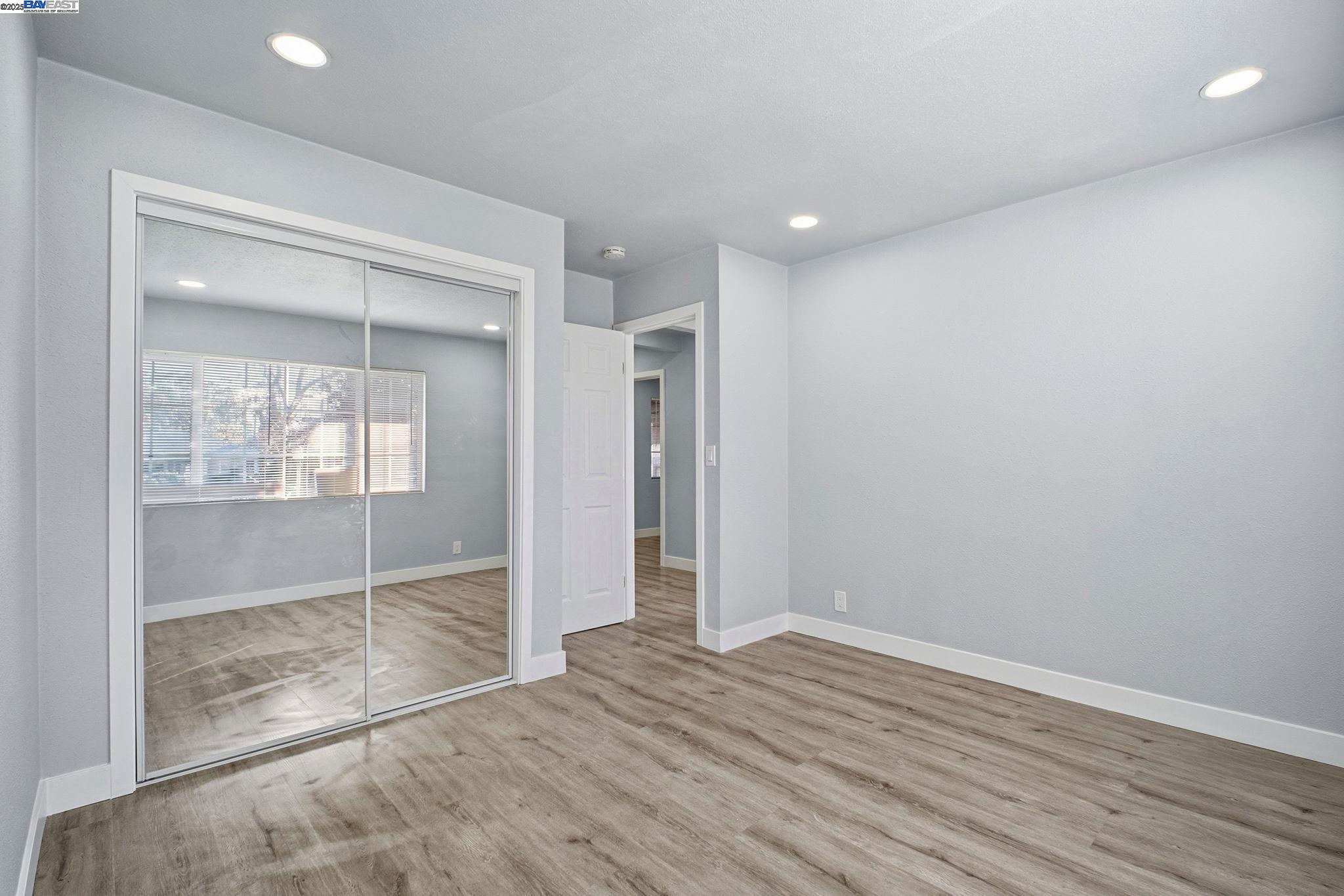 38016 Vallejo Street Fremont, CA 94536 - Photo 13 of 32 an empty room with wooden floor and door