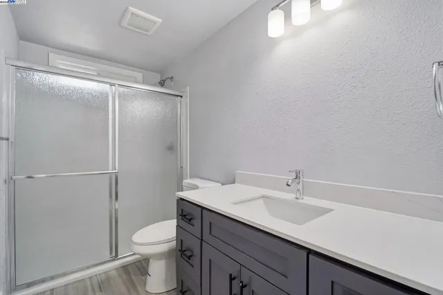 a bathroom with a glass shower door