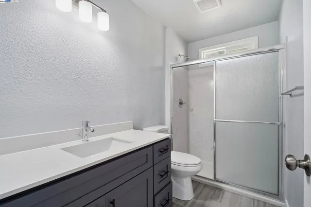 a bathroom with a shower and mirror