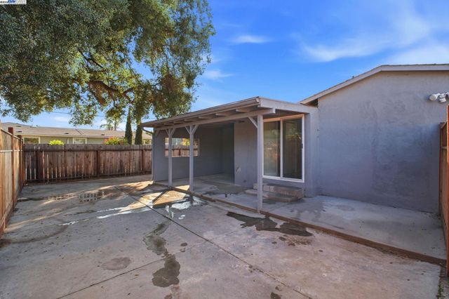 a view of a backyard with wooden fence