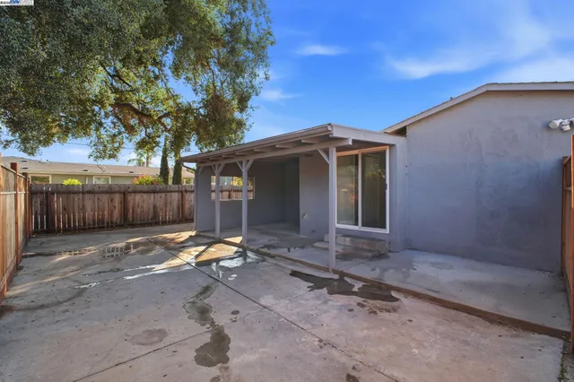 a view of a backyard with wooden fence