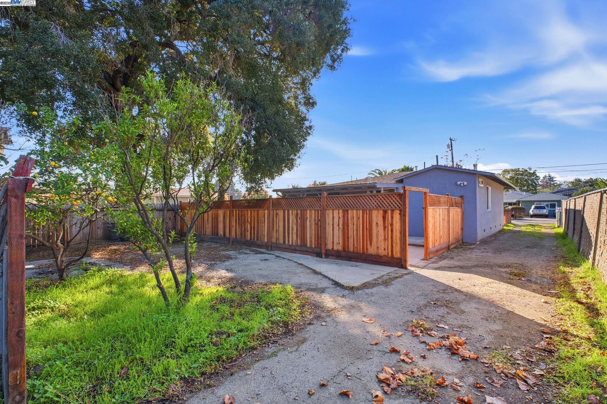 38016 Vallejo Street Fremont, CA 94536 - Photo 30 of 32 a front view of a house with a yard and table and chairs