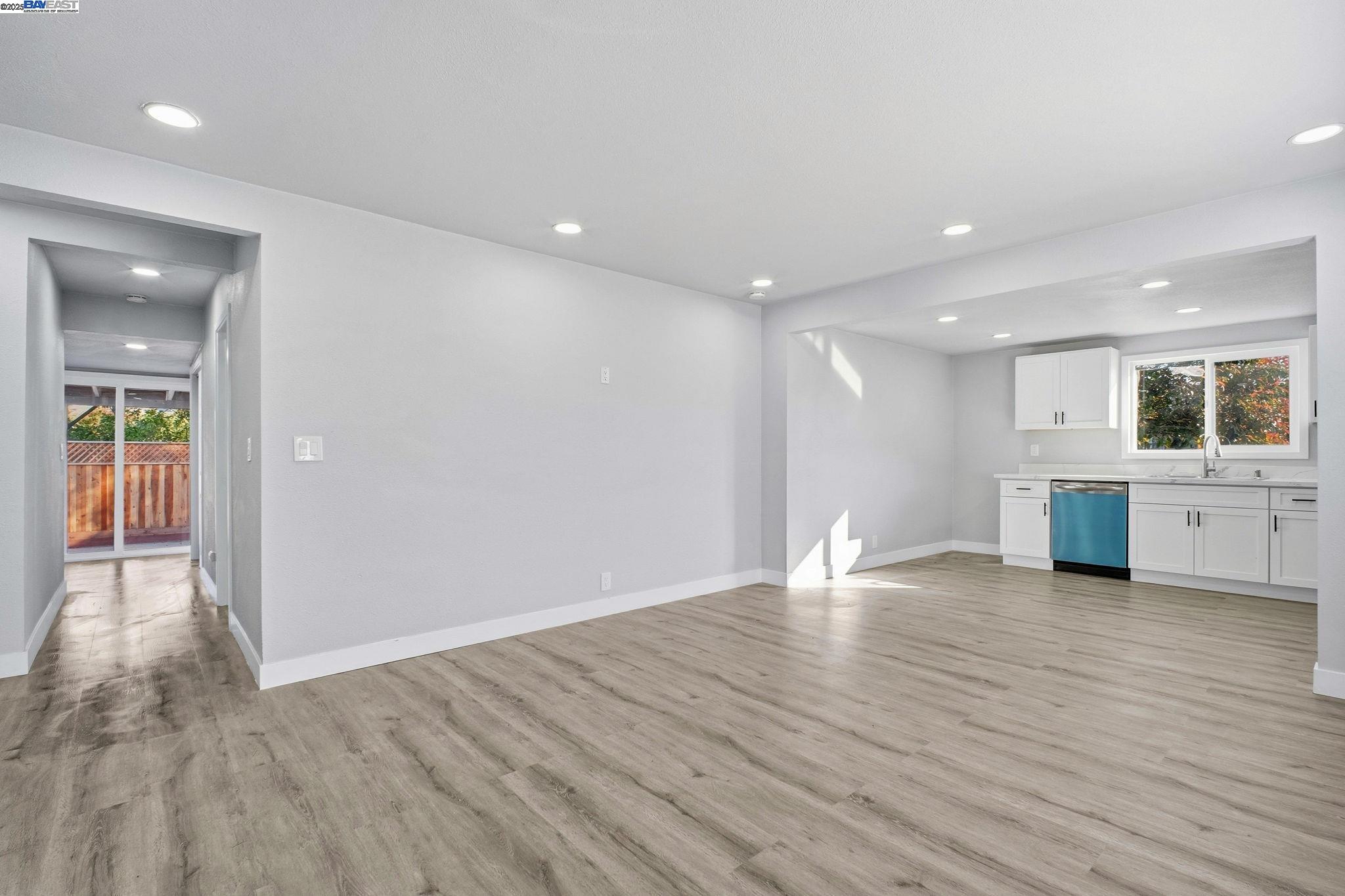 38016 Vallejo Street Fremont, CA 94536 - Photo 5 of 32 a view of an empty room with wooden floor and kitchen